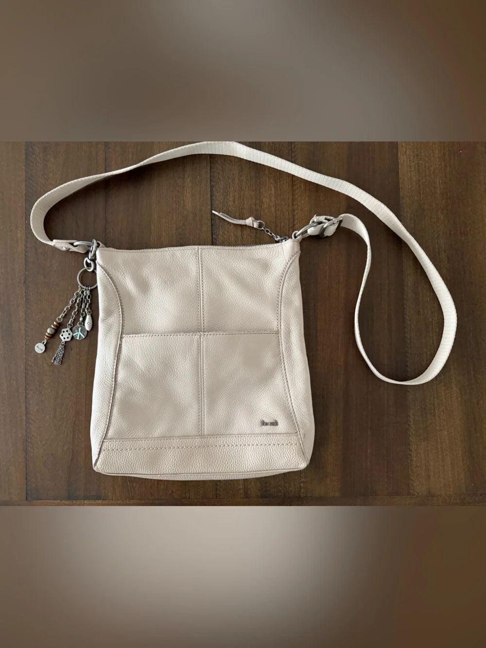 The Sak Soft Pebbled Cream Leather Crossbody with Charm Tassel